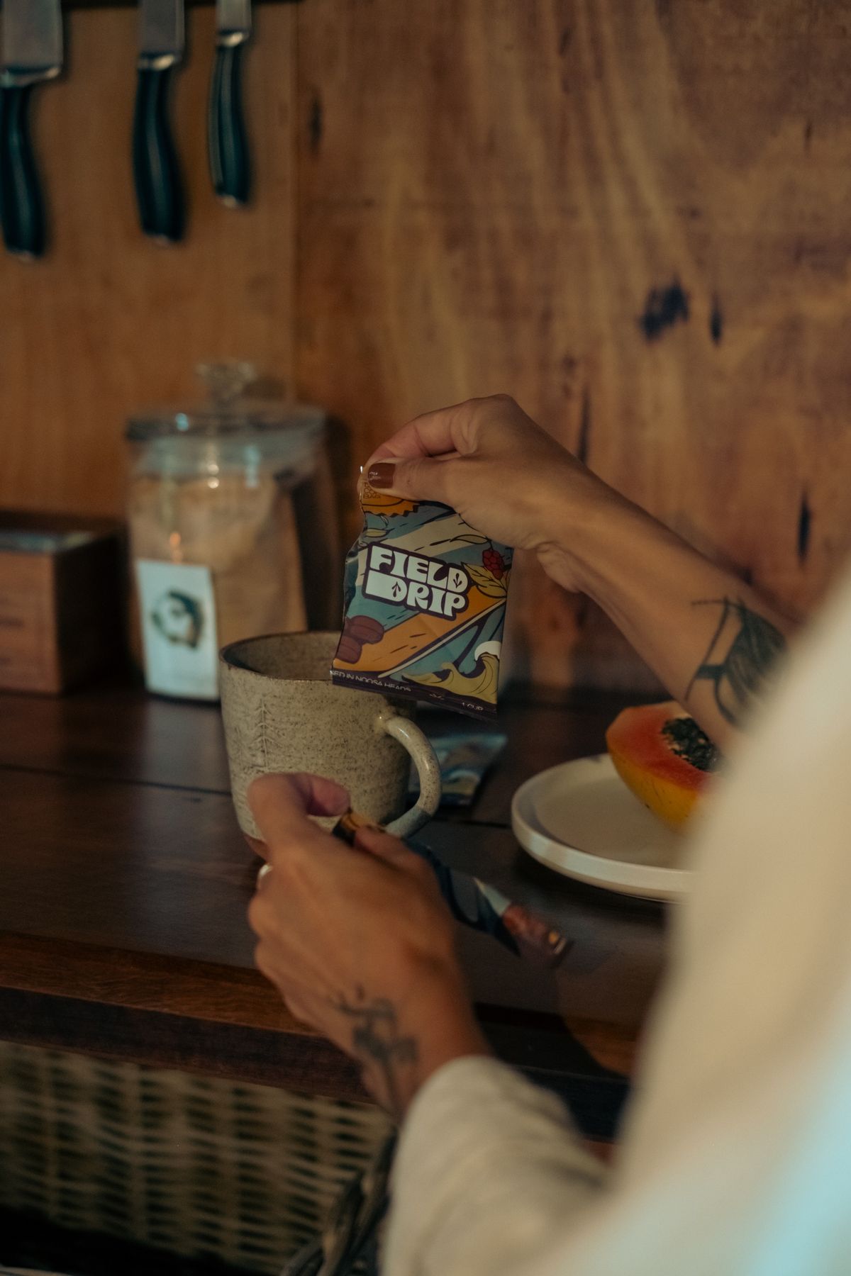 Pouring a Field Drip coffee bag into a mug